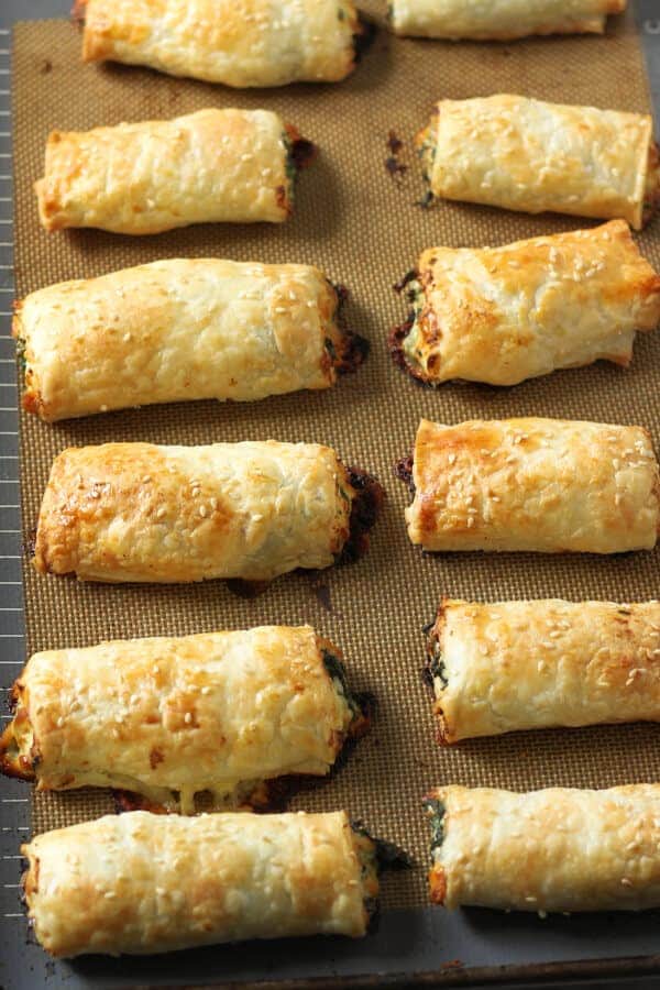 spinach and ricotta rolls on a baking tray.