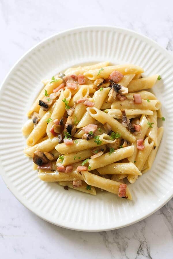 Creamy Carbonara on a white plate.
