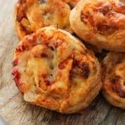 pizza rolls on a wooden board.