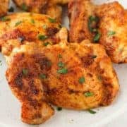 chicken thighs on a plate with parsley.