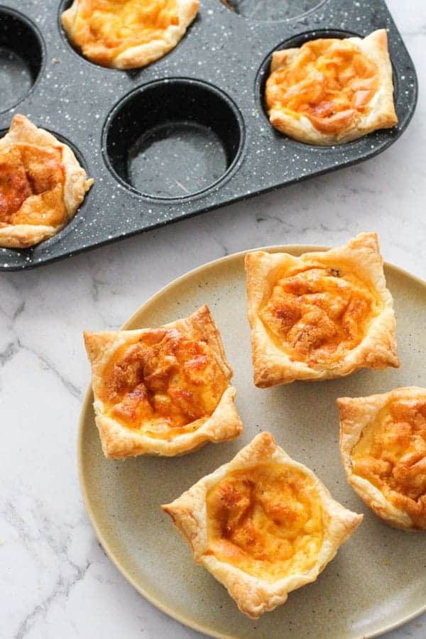 mini bacon and egg pies on a plate.