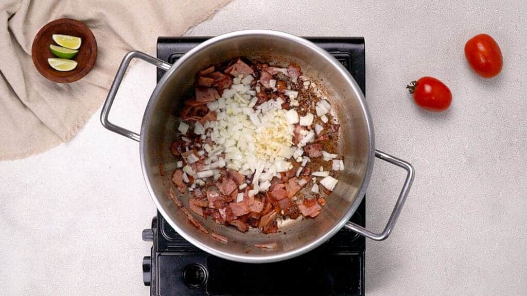 Add onion and garlic to the charros pot