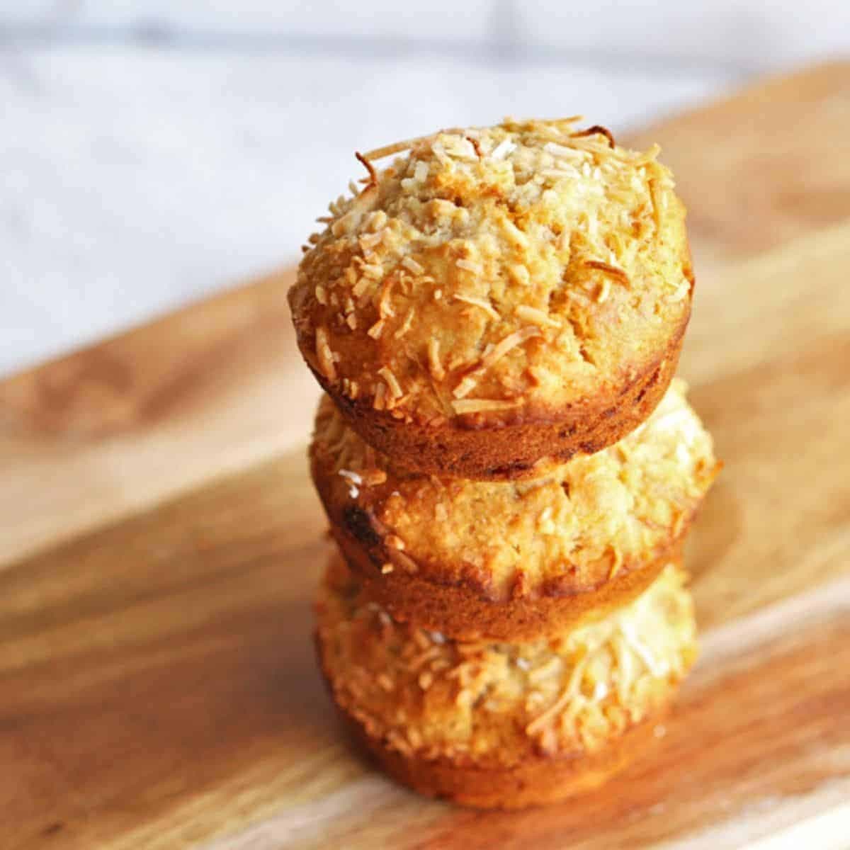 banana coconut muffins stacked on top of each other.