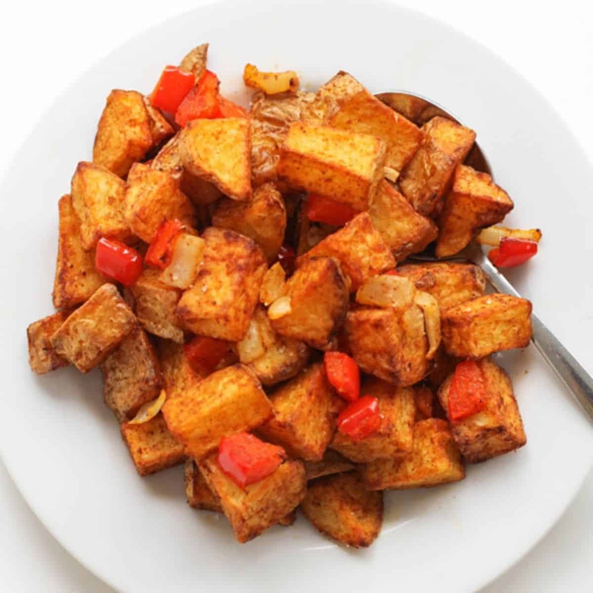 breakfast potatoes on a white plate.