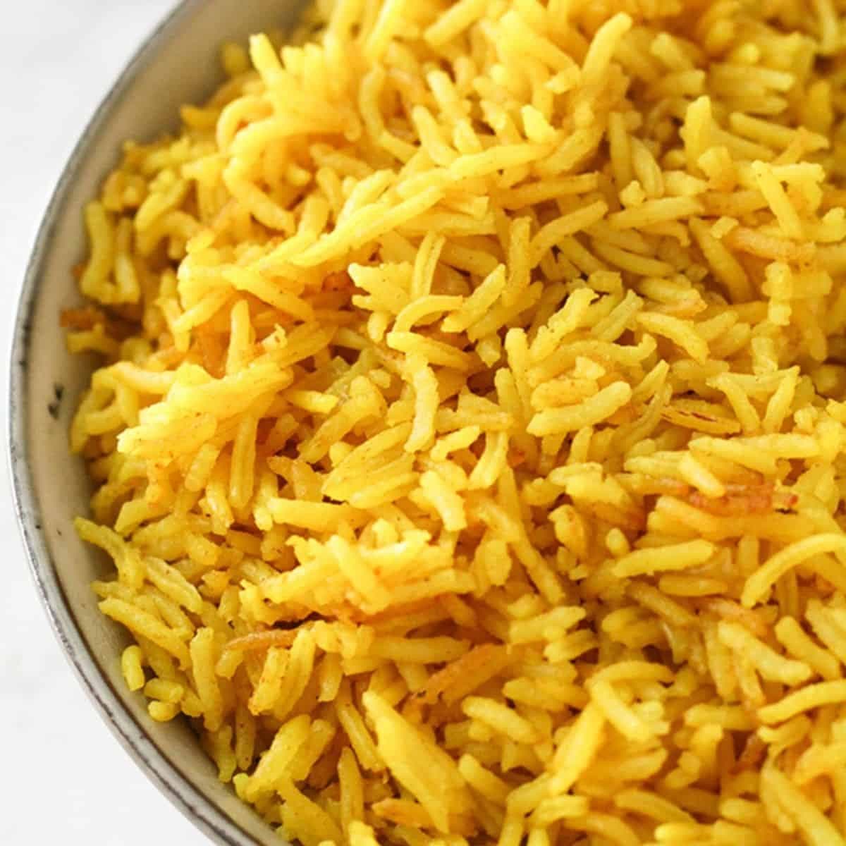 yellow rice in a grey bowl.