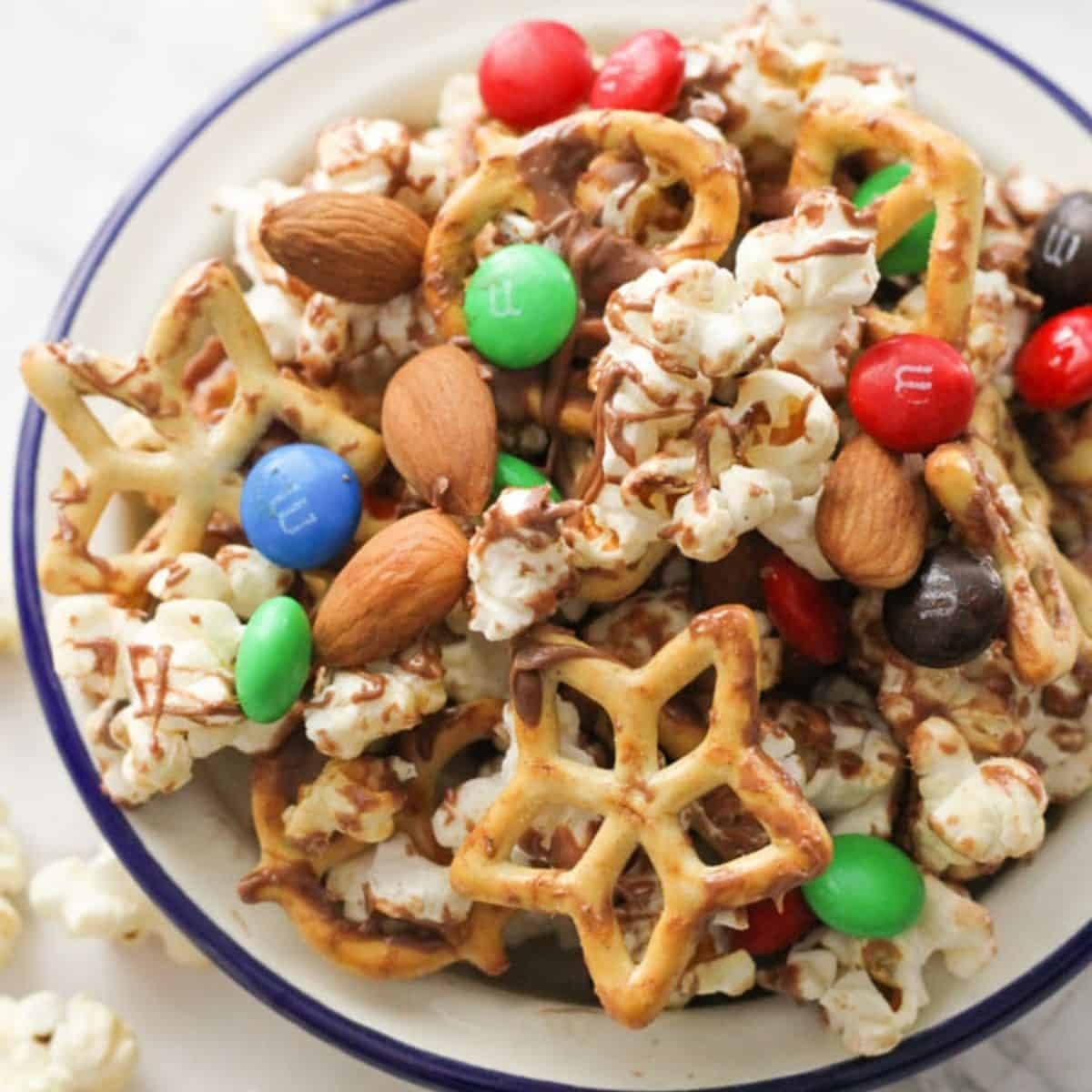popcorn trail mix in a white serving bowl.