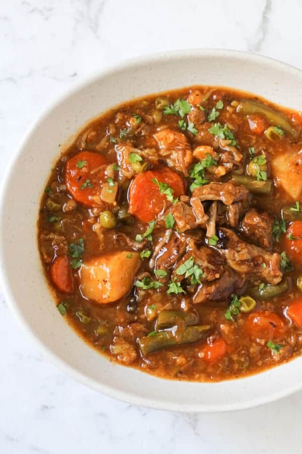 beef and vegetable stew in a white bowl