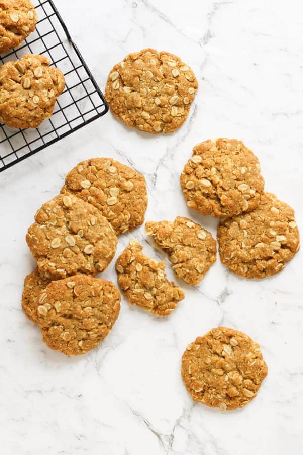 anzac biscuits scattered on a marble background.