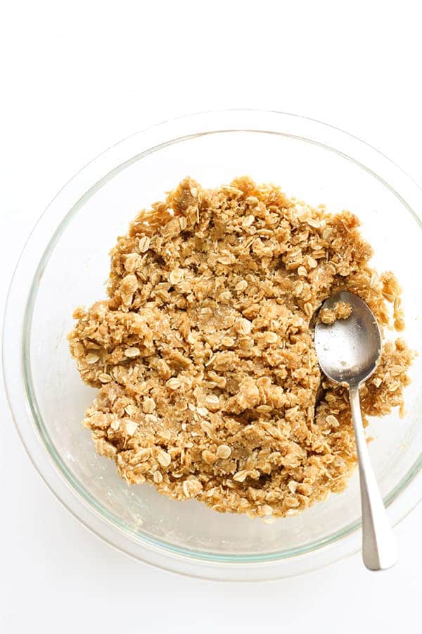 anzac biscuit mixture in a glass mixing bowl.