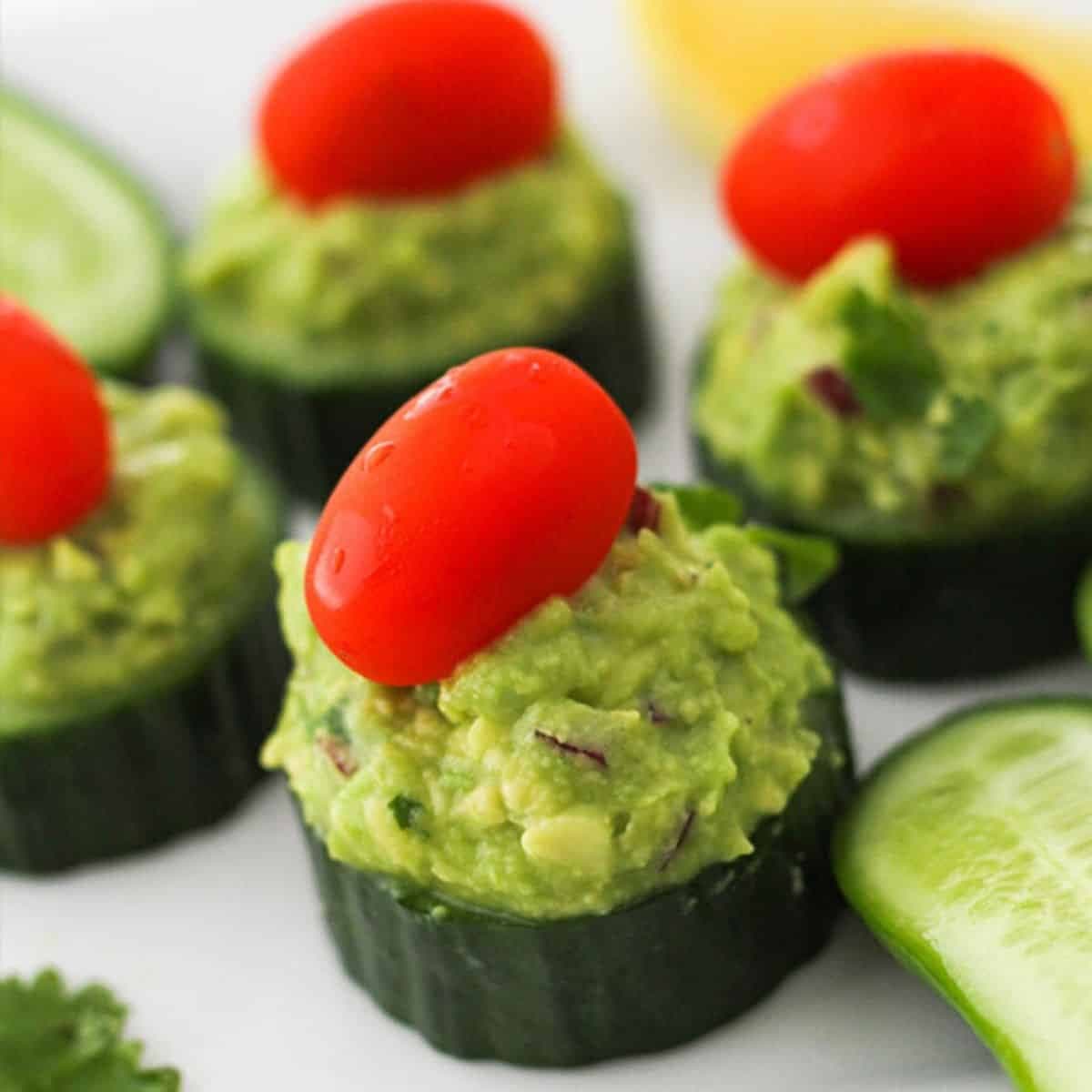 cucumber bites on a white plate.