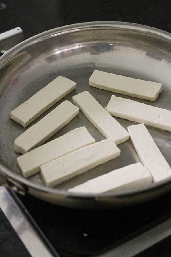 tofu slices in a frying pan.