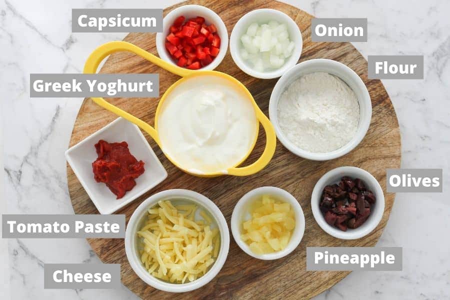 pizza roll ingredients on a wooden board.