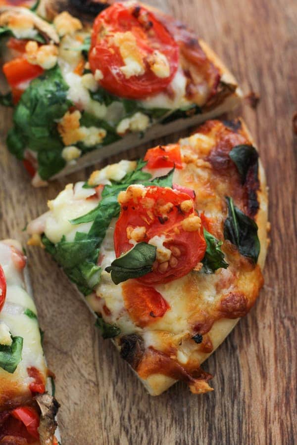 slice of pizza on a wooden board.