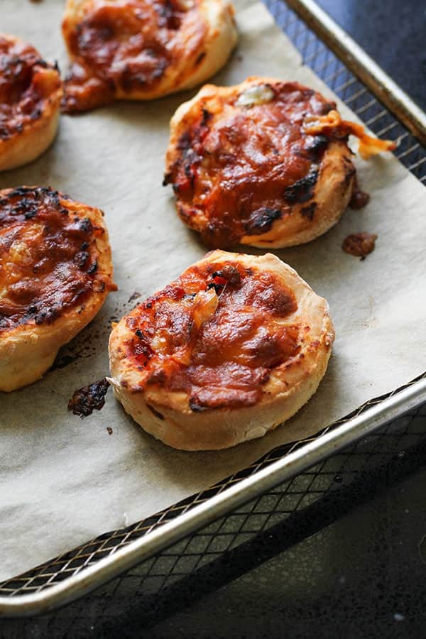 cooked pizza pinwheels on an air fryer wire tray.