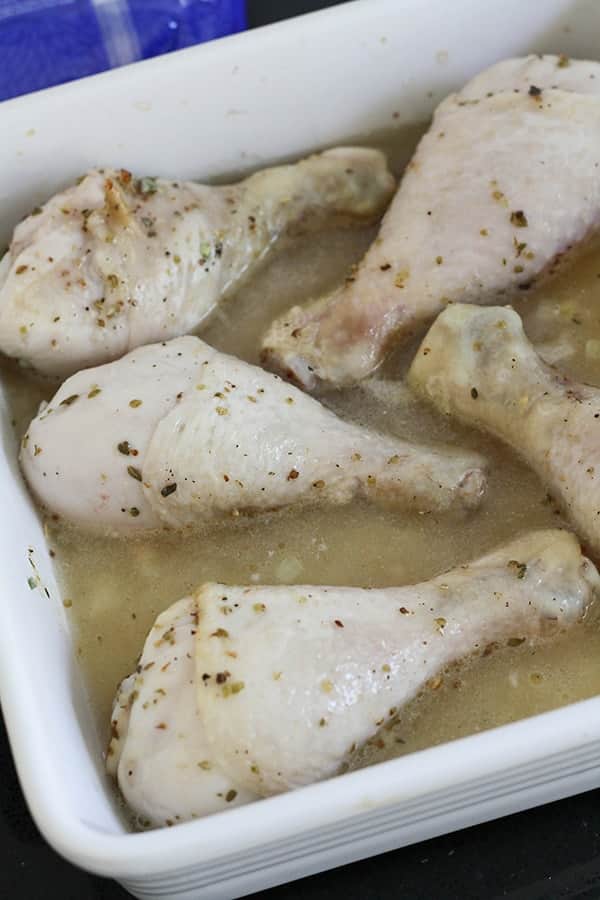 chicken drumsticks in a baking dish.