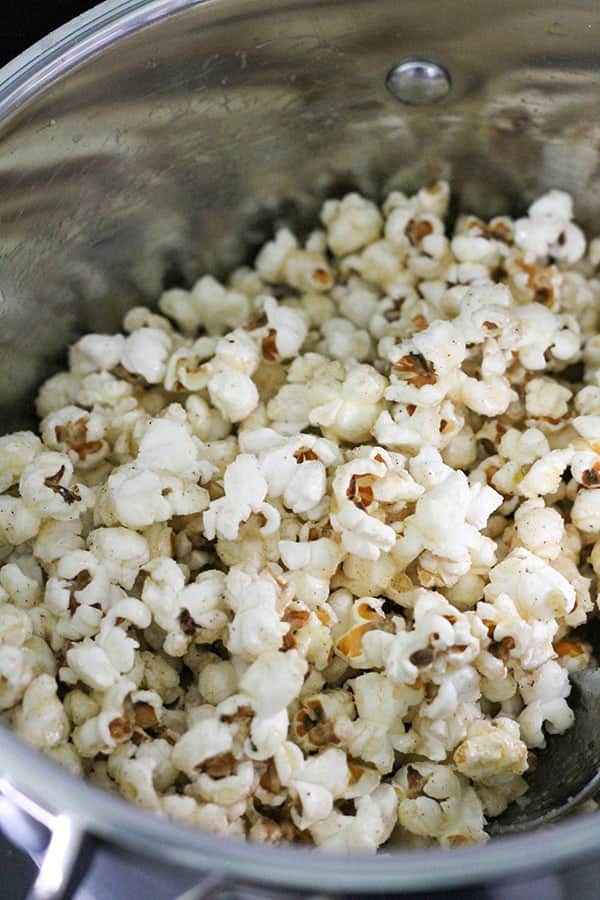 popcorn covered in butter and sugar in a saucepan.