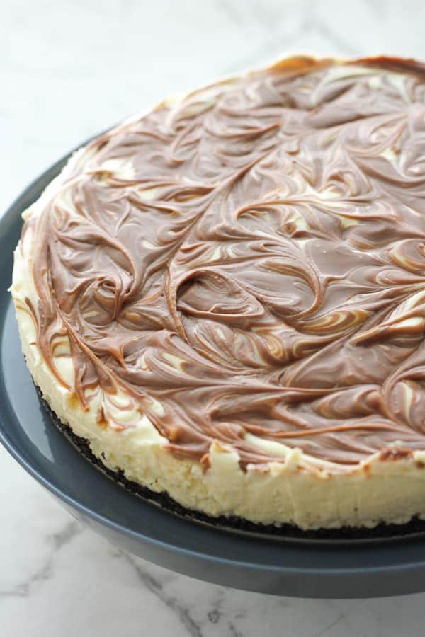 cheesecake on top of a cake stand.