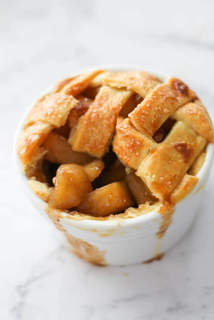 mini apple pie in a white ramekin.