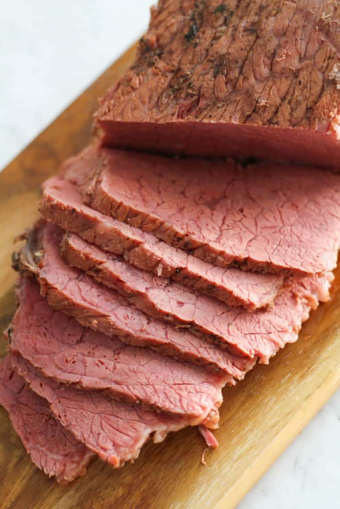 slices of the meat on the wooden serving tray