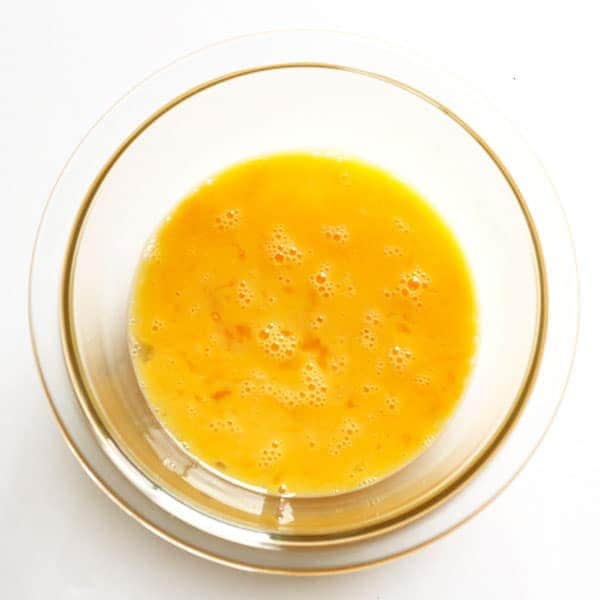 whisked eggs in a glass bowl
