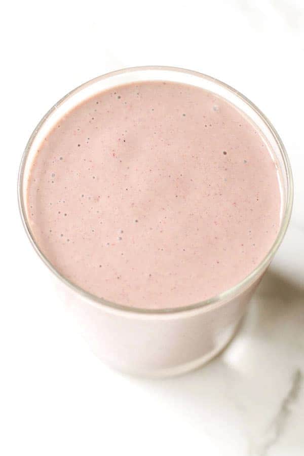 mixed fruit smoothie in a small glass