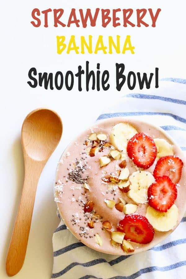 strawberry banana smoothie bowl with a wooden spoon