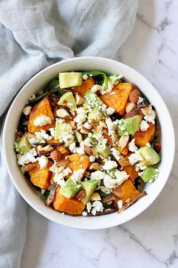 sweet potato, avocado and feta salad in a white bowl