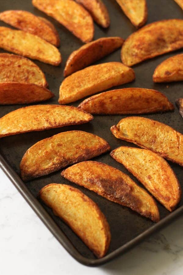 potato wedges on a baking tray.