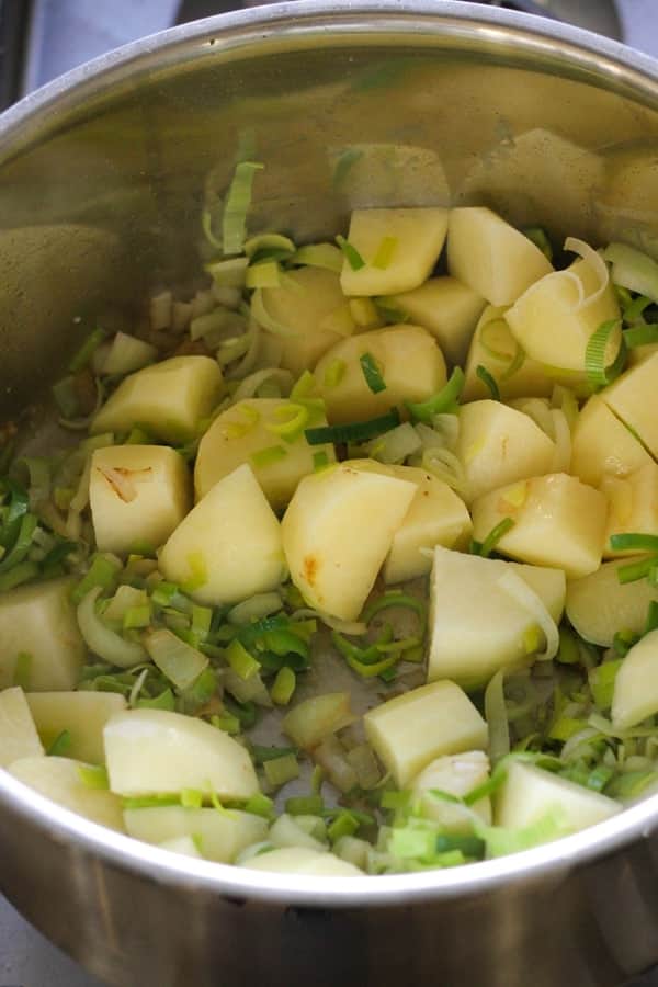 potato and leek soup ingredients in a saucepan. 