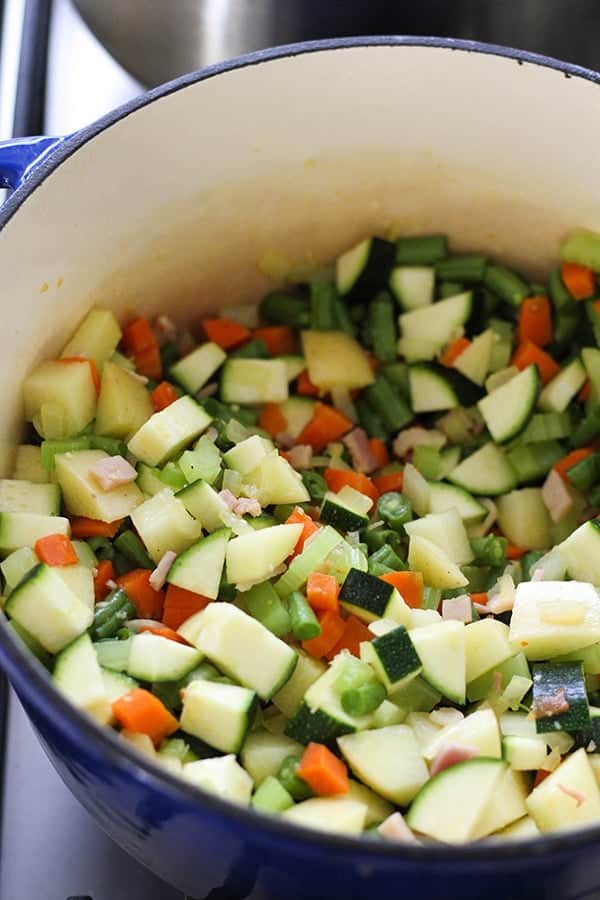 Italian Minestrone Soup ingredients in a dutch oven.