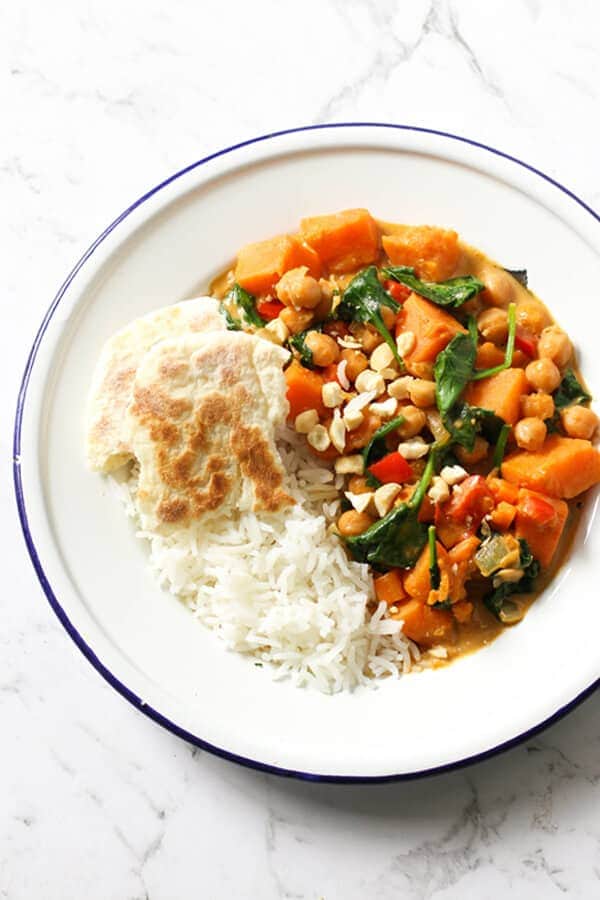 sweet potato, chickpea and spinach curry in a bowl with rice