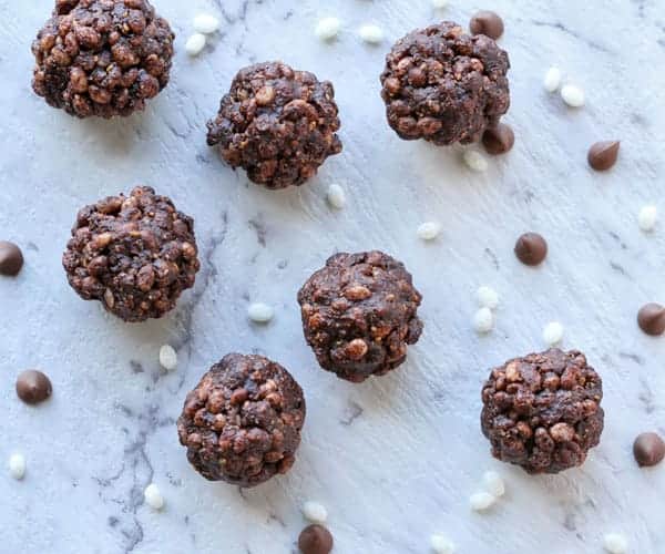 healthy chocolate crackles laying on a white background