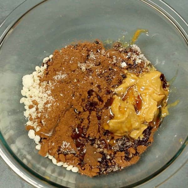 healthy chocolate crackles ingredients in a glass mixing bowl 
