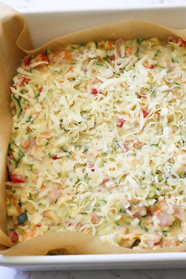 Zucchini and Bacon Slice ingredients in a baking tray ready for the oven. 