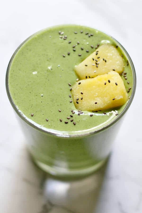 Kale Pineapple Smoothie topped with pineapple pieces and chia seeds