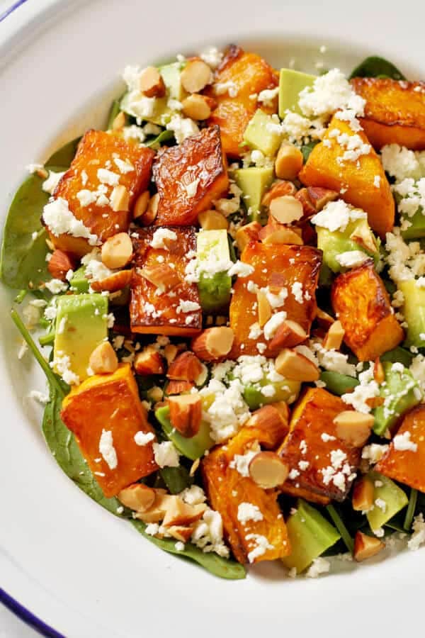 roast pumpkin, spinach and feta salad on a white plate