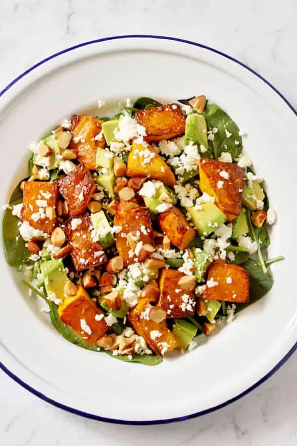 roast pumpkin, spinach and feta salad on a white plate