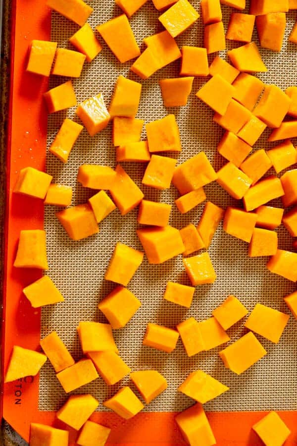 pumpkin pieces on a roasting tray