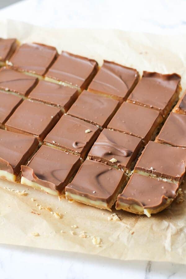 chocolate caramel slice on brown baking paper