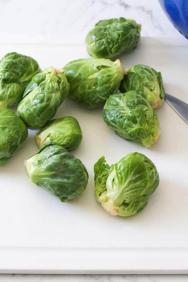 brussels sprouts scattered on a cutting board
