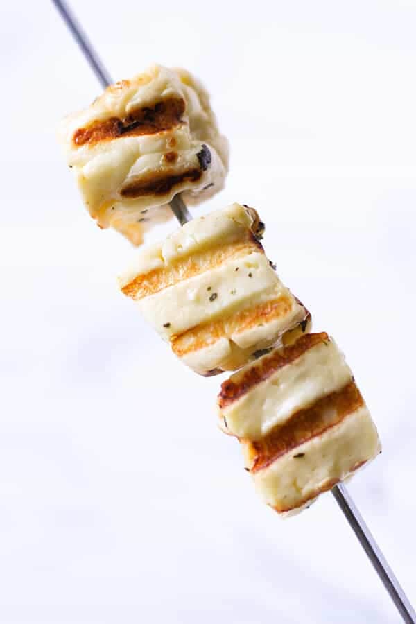 grilled halloumi cubes on a skewer.