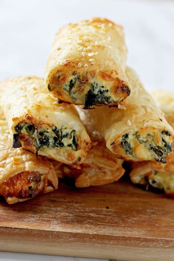 spinach and ricotta rolls stacked in a pyramid shape.