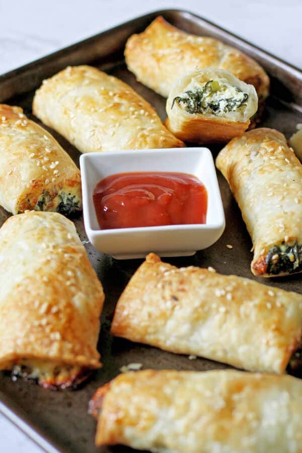 spinach and ricotta rolls on a baking tray.