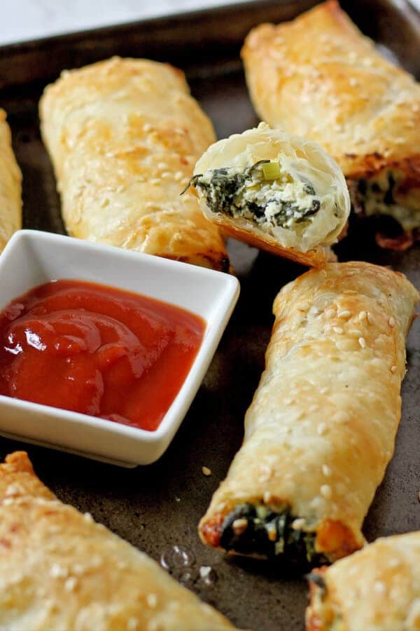 spinach and ricotta rolls on a baking tray.