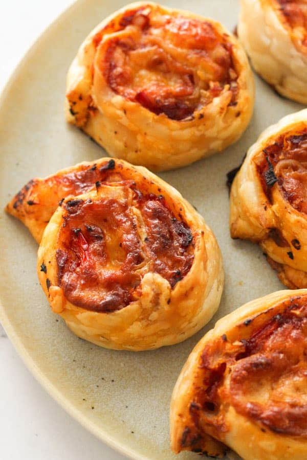 pizza pinwheels on a grey plate.
