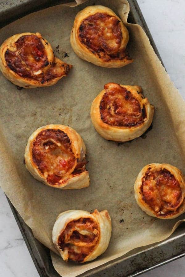 pizza pinwheels on a baking tray.