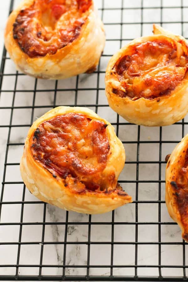 pizza pinwheels on a wire cooling rack.