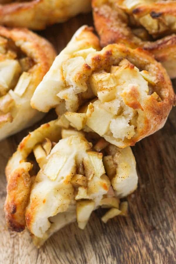 apple cinnamon rolls on a wooden board.