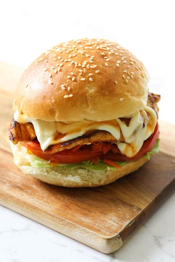 Grilled Chicken Burger on a wooden board.