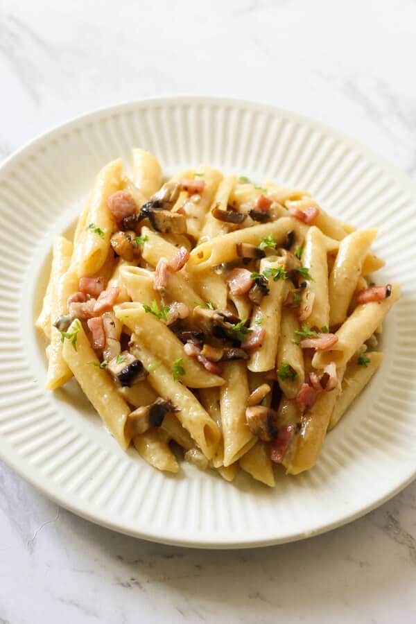 Creamy Carbonara on a white plate.